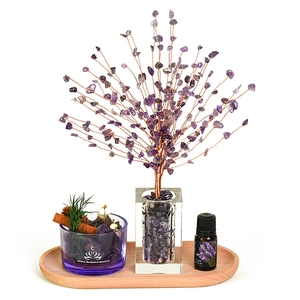 Amethyst crystal tree set with aromatherapy diffuser stones and essential oil on wood tray
