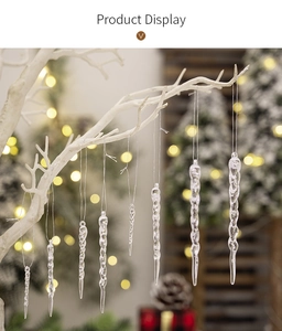 Close-up of clear acrylic Christmas icicle ornaments with spiraled texture on white branch