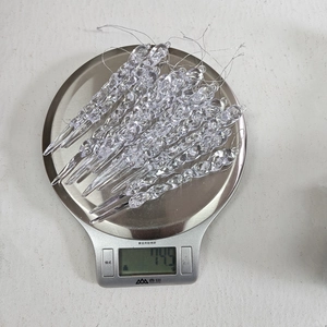 Detailed view of 12pcs clear acrylic icicle ornaments on a digital scale weighing 14.5g