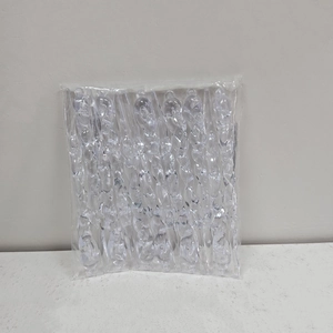 Detailed view of clear acrylic spiral icicle ornaments in bulk transparent packaging