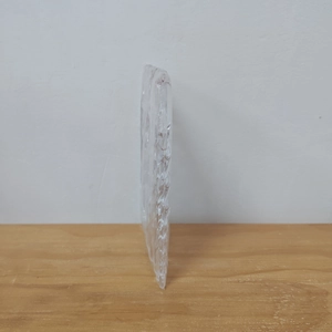 Detail of transparent acrylic snowflake pendant with textured surface for Christmas decor