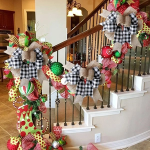 Staircase decorated with Christmas swags featuring red, green ornaments and plaid bows