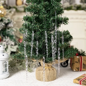 Set of clear acrylic icicle ornaments hanging on a Christmas tree for holiday decor