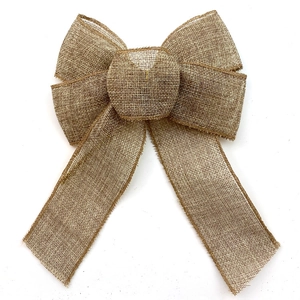 Macro detail of natural burlap bow ornament with woven rustic fiber texture for Christmas