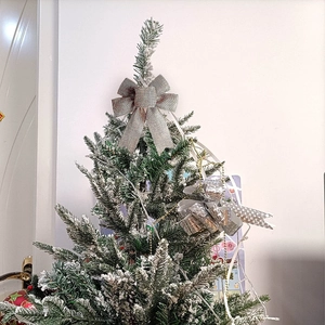 Frosted Christmas tree decoration with grey linen bow and silver ribbon accents