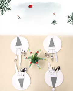 Christmas mini hat cutlery holders set with stainless steel knife fork on white ceramic plate