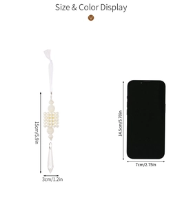 Detail showing pearl matrix and crystal drop ornament next to a phone for size scale
