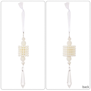 Detail of elegant pearl cube ornament with faceted crystal teardrop for home decor