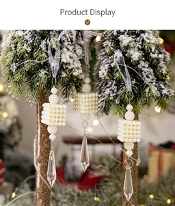 Detail of beaded pearl square ornaments with crystal icicles on a snowy Christmas tree