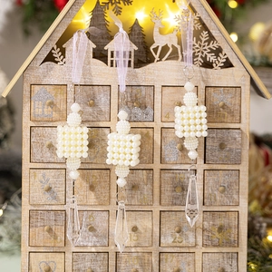 Close-up of pearl cube and crystal droplet Christmas ornaments with lavender ribbons