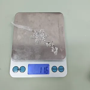 Detailed view of acrylic snowflake ornament weighing 11.6g on a digital scale