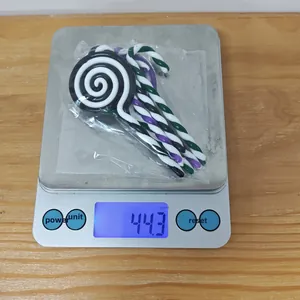 Close-up of colorful spiral candy ornaments weighed on a scale for Christmas DIY crafts
