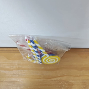 Close-up of red and white Christmas candy cane ornaments in protective packaging