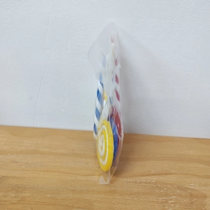Macro side view of colorful spiral candy ornaments in clear OPP packaging