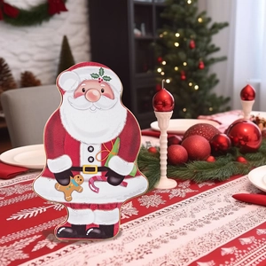 Macro view of Santa Claus tin gift box on a festive Christmas dining table setting