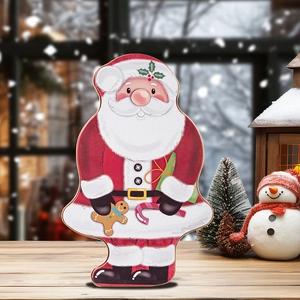 Detail of Santa Claus tin gift box showing creative holiday decoration on wooden table
