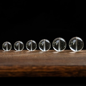 Cuentas de cuarzo cristal natural en seis tamaños para bisutería sobre madera oscura