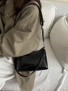 Glossy black square shoulder bag with wide strap and geometric design for women