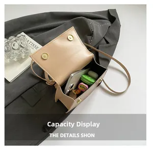 Beige mini flap bag interior showing capacity for smartphone and everyday essentials