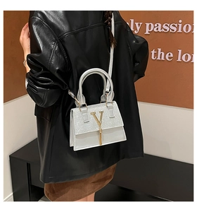 Detail of silver sequin crossbody bag with gold V buckle and tassel fringe for women