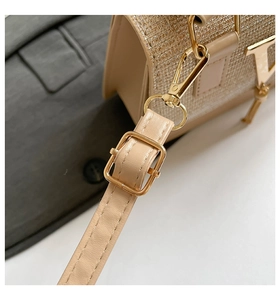 Close-up of champagne gold mini bag featuring metal lobster clasp and adjustable strap detail