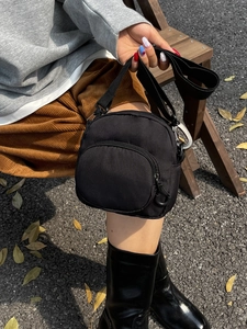 Fashionable black large capacity nylon crossbody bag with adjustable strap and front pocket