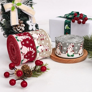 Detail of Christmas ribbons in red, beige and grey with festive gnome and snowflake patterns