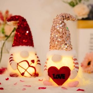 Pair of lighted Valentine Gnomes with sequins and heart decor on a plush background