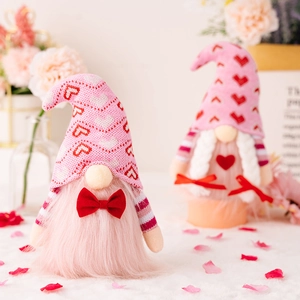 Romantic pink Valentine's Day gnome figurines with heart patterns and plush textures