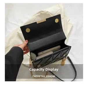 Internal view of black quilted chain bag showing capacity for a smartphone and daily items
