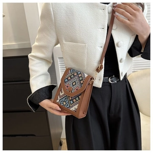 Ethnic style crossbody phone bag with colorful geometric woven pattern and leather trim