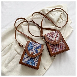Ethnic style mini crossbody phone bags with intricate woven patterns in blue and red