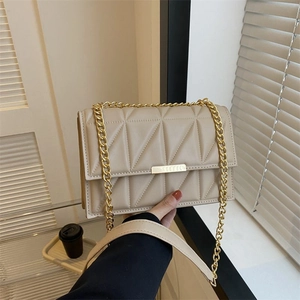 Quilted crossbody chain bag in beige featuring geometric patterns and gold clasp