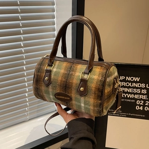 Vintage green plaid woolen boston bag with brown leather handles and golden hardware