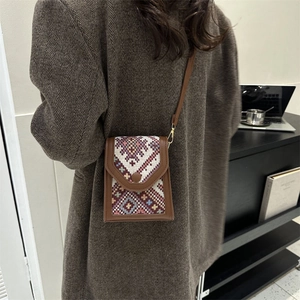 Ethnic style crossbody phone bag with brown leather trim and geometric woven pattern