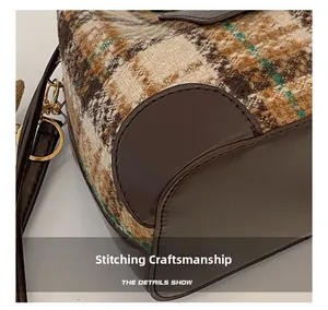 Detailed view of autumn plaid tweed bucket bag with leather stitching and golden hardware