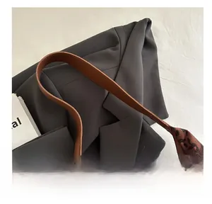 Close-up of leopard print tote bag with premium brown leather handle and stitching