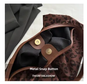 Detail shot of the metal magnetic closure on this stylish leopard print tote bag