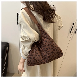 Model wearing vintage leopard print tote bag with wide strap for daily commute