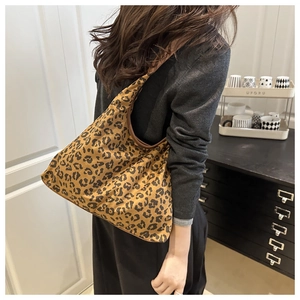Macro shot of the leopard print pattern and fabric texture of the vintage hobo tote bag
