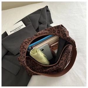 Top view of leopard print tote bag interior showing large capacity for books and umbrella