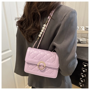 Detail of light purple quilted bag featuring pearl chain strap and metal buckle