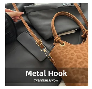 Close-up of leopard print bucket bag featuring premium gold-tone metal hardware hooks