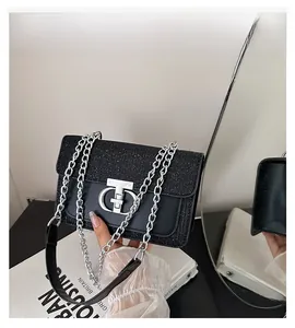 Close-up of black sequin stitching and silver metal buckle on the shoulder bag