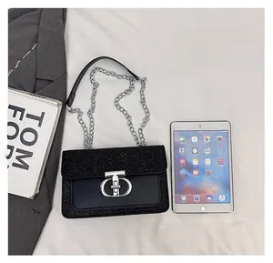 Detail of sequined chain bag showing silver metal lock and size comparison with objects
