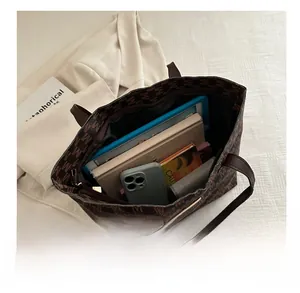 Detailed interior view of a brown monogram tote bag showing large storage capacity