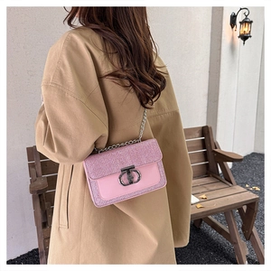 Detail of pink sequin crossbody bag with silver chain strap and metallic clasp