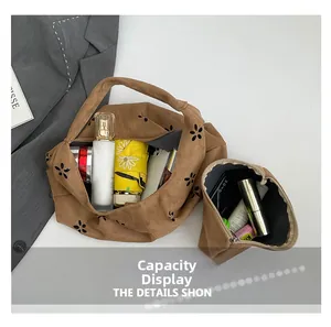 Detailed interior capacity of brown suede petal tote bag with floral laser-cut patterns