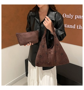 Detail of hobo bag set featuring laser-cut floral patterns in premium brown suede leather