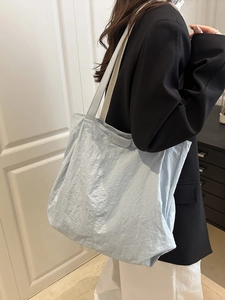 Light blue large capacity tote bag with pleated texture and wide shoulder strap